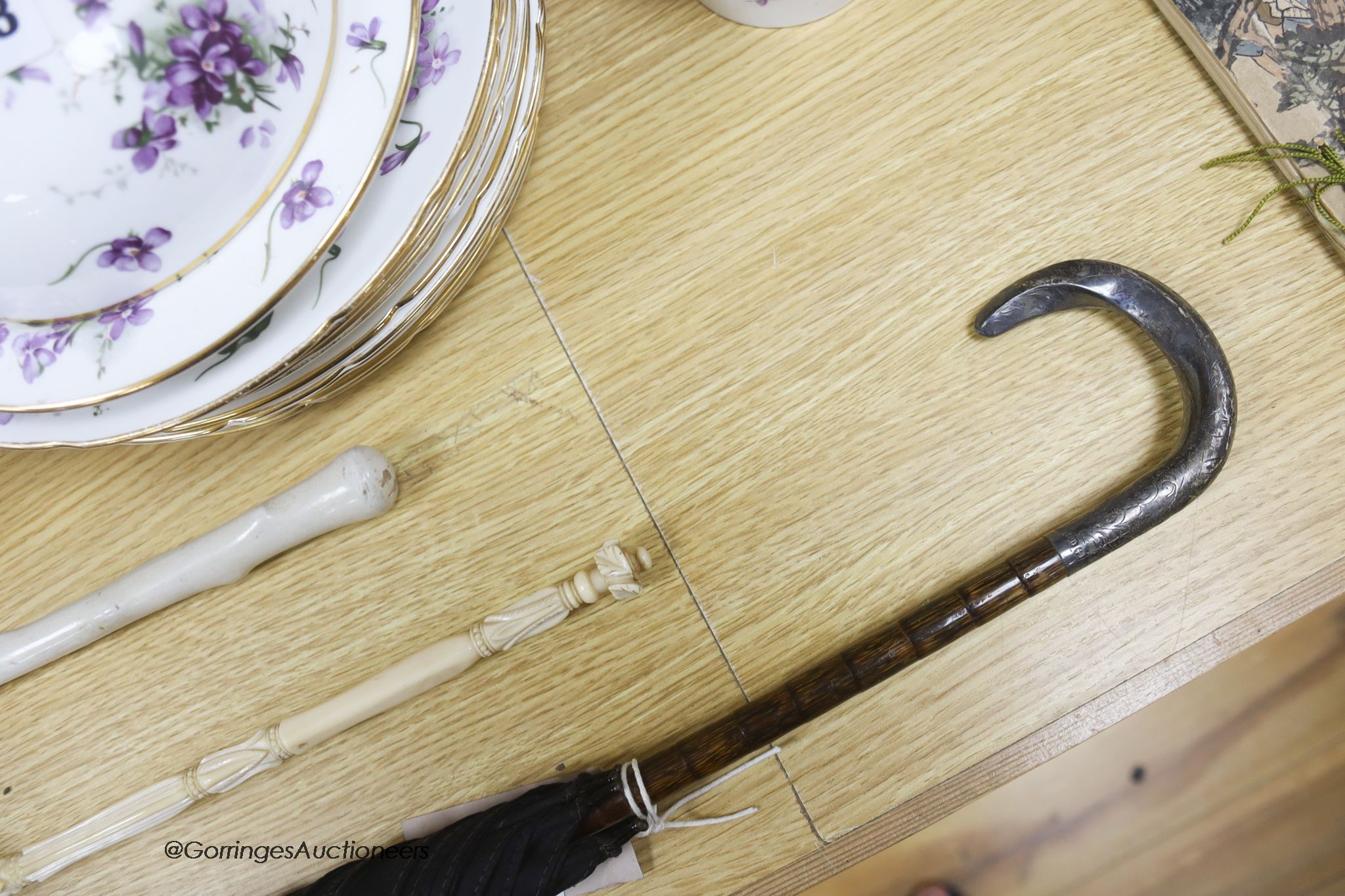 A silver mounted handled umbrella, an ivory handle parasol and a chantilly lace parasol